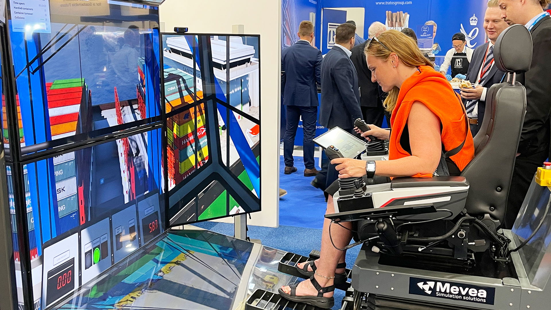 Visitors testing Mevea Pro Crane Simulator in action at TOC Europe 2022.